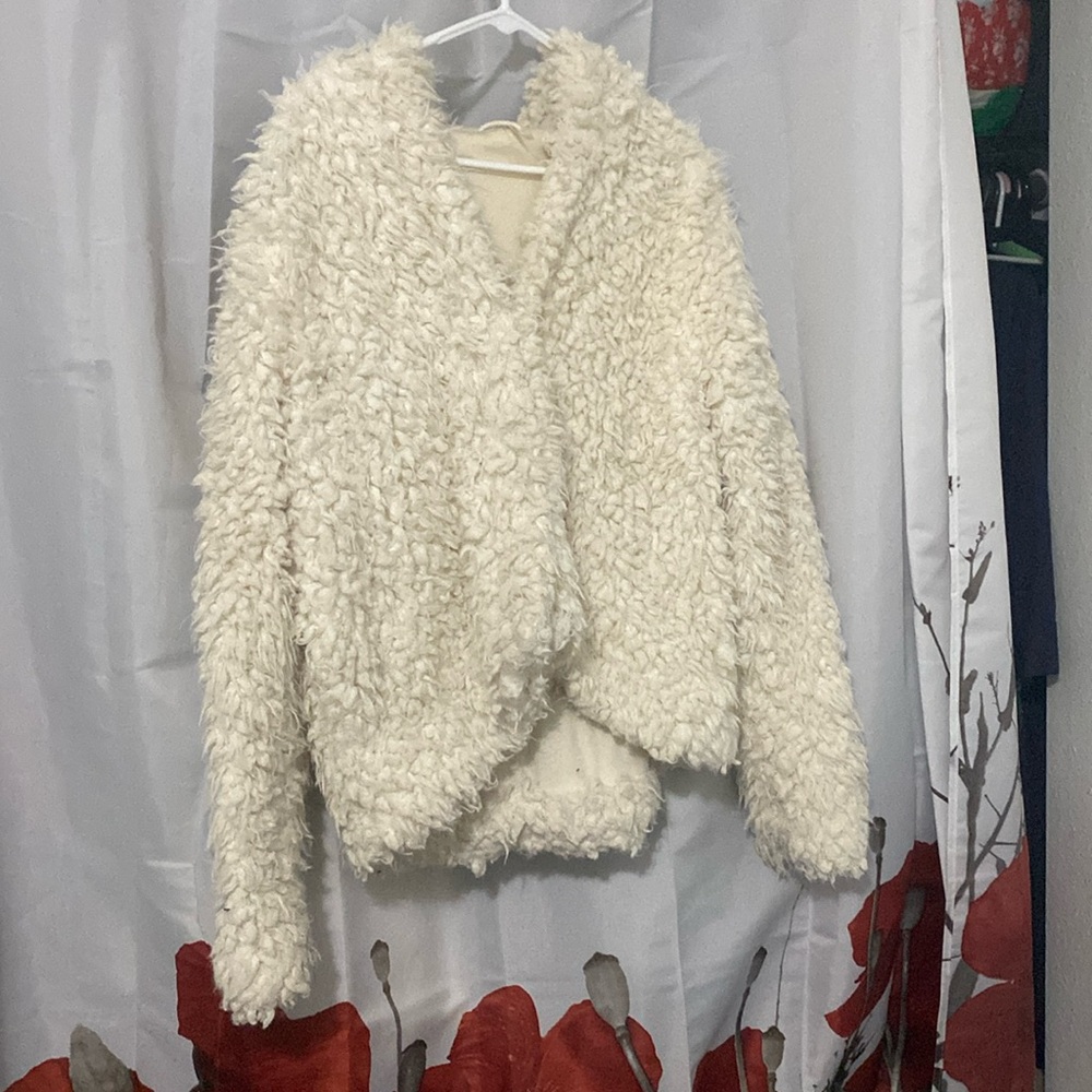 Free people size S soft fluffy jacket with hood and pockets.